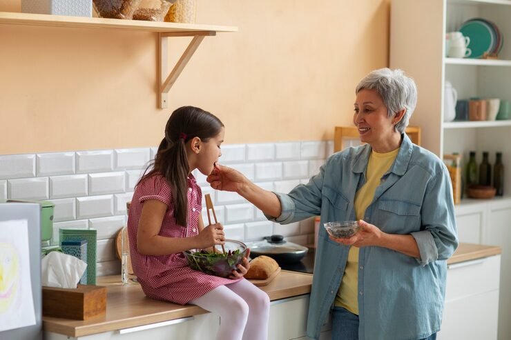 medium-shot-grandma-girl-cooking-together_23-2150363895
